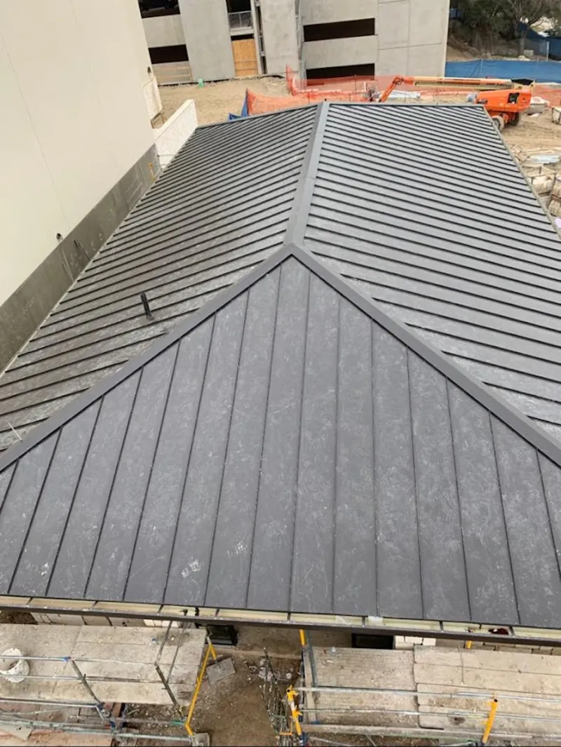 Commercial metal roof construction with crane equipment in Lyndhurst