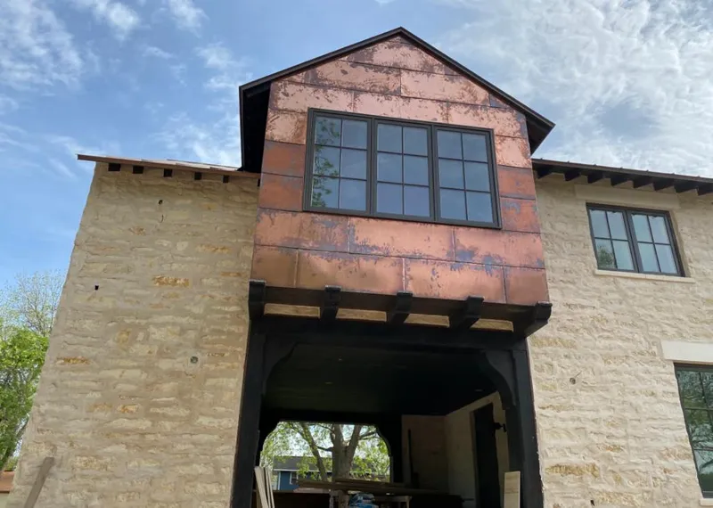 Copper metal panel facade on a stone building for Skylight Installation in Lyndhurst